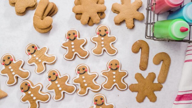 Photo decorating gingerbread cookies with royal icing for christmas.