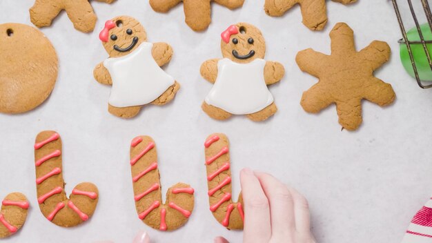 Decorating gingerbread cookies with royal icing for Christmas.