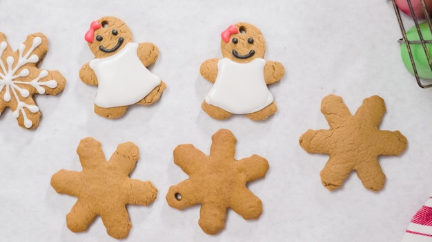 Decorating gingerbread cookies with royal icing for Christmas.