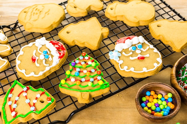 Decorating gingerbread cookies with royal icing and colorful candies.