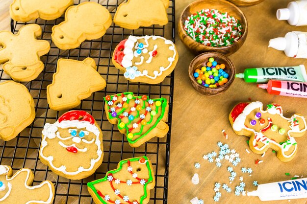 Decorating gingerbread cookies with royal icing and colorful candies.