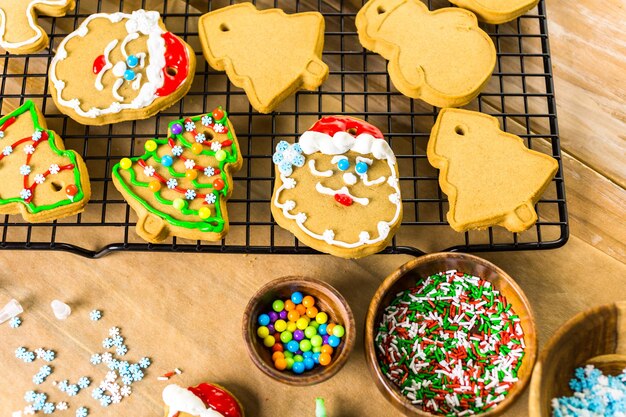 Decorating gingerbread cookies with royal icing and colorful candies.