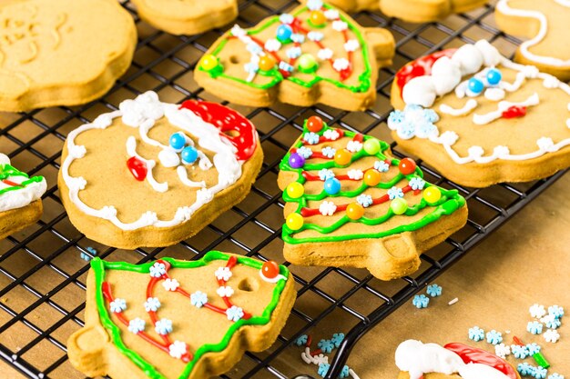 Decorating gingerbread cookies with royal icing and colorful candies.