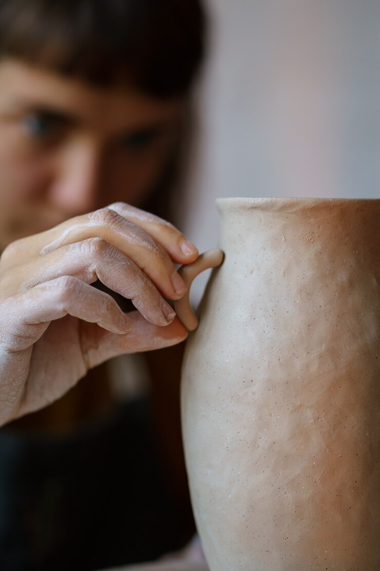 Photo decorating pottery female ceramics shaping potter jug while art class in handicraft workshop studio