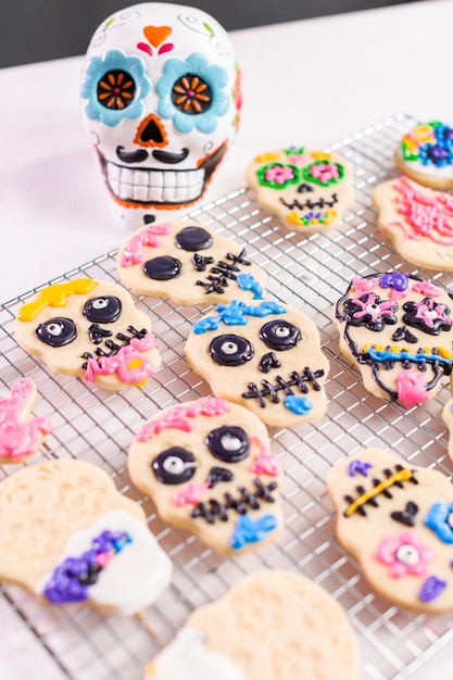 Decorating sugar cookies with royal icing for Dia de los Muertos holiday.