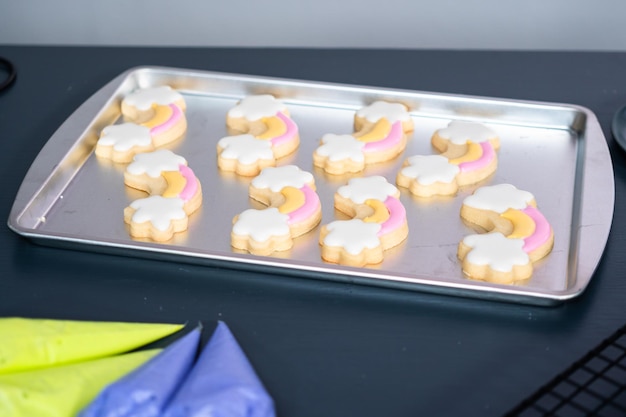 Decorating unicorn sugar cookies with royal icing.