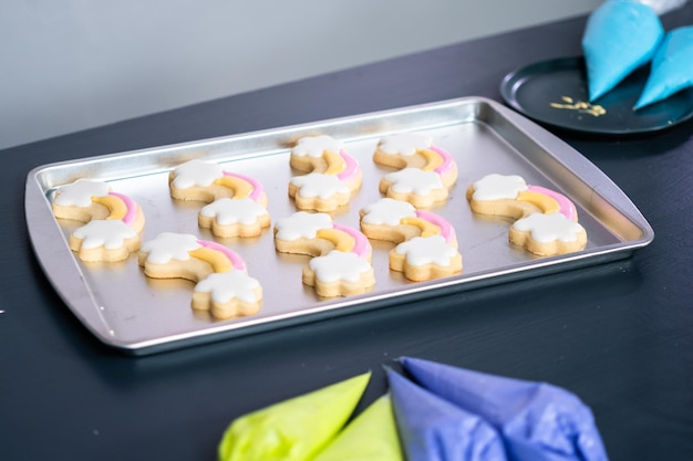 Decorating unicorn sugar cookies with royal icing.