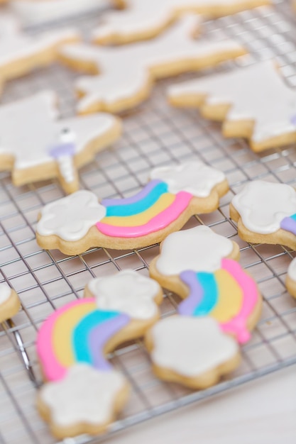 Decorating unicorn themed sugar cookies with royal icing.