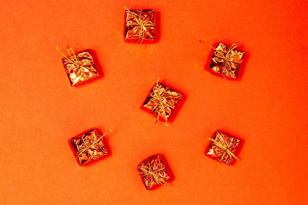 Decoration christmas concept Golden gift box arrangement on orange background