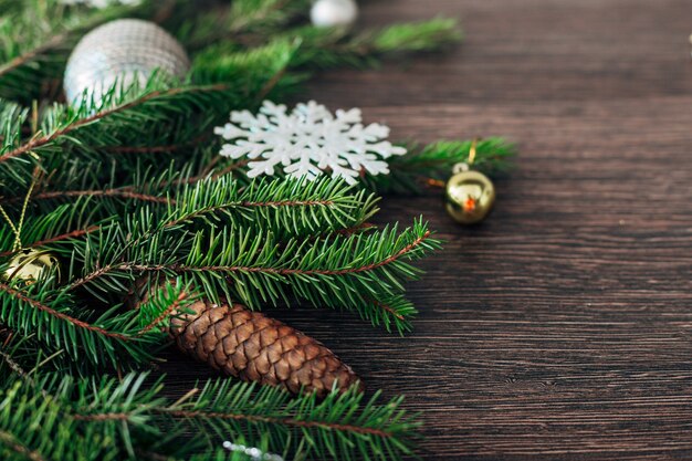 Decoration of Christmas Tree Green Branches on a Brown Background with Copy Space