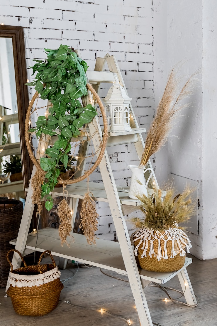 Photo decoration for cozy home made with dry herbs, lantern, candles and garlands on brick wall.dried flowers and vegetation in a modern interior. interior decor in eco-style