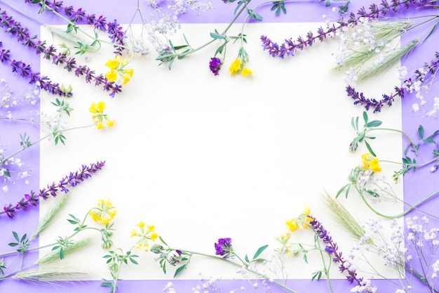 Decoration of flowers on white paper over the purple background