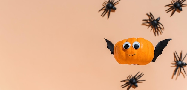 Decoration for Halloween kids party flying cute pumpkin head with eyes and funny face Pumpkin monster witch vampire crawling spiders Copy space promotion Halloween banner Levitation