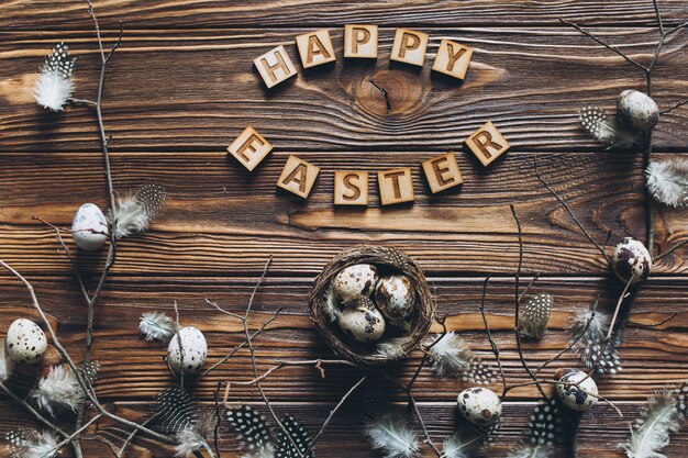 Decoration with quail eggs, nest and feathers.