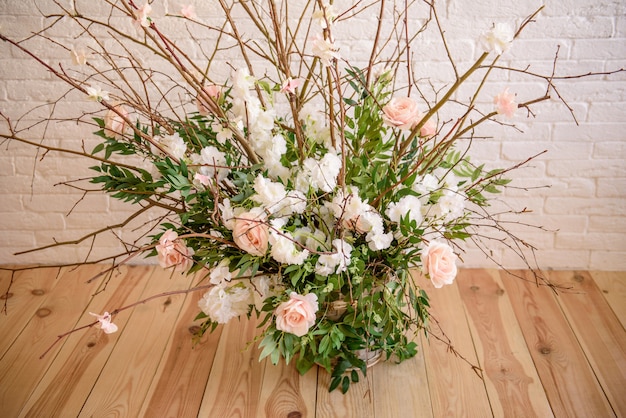 Decorations of branches with beautiful pink and white flowers in the basket