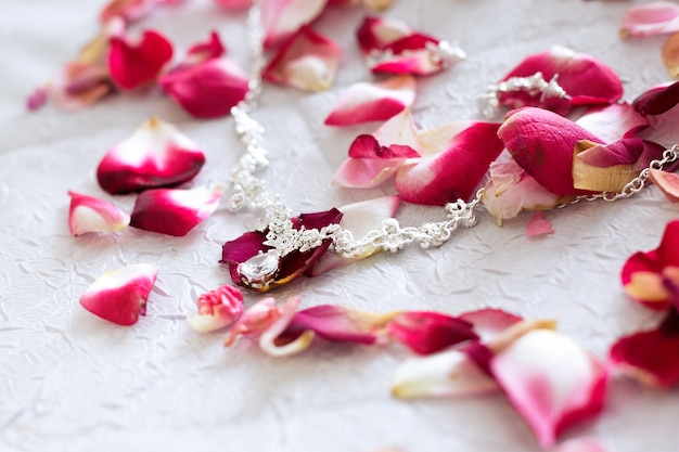 Decorations for the bride are spread among rose petals