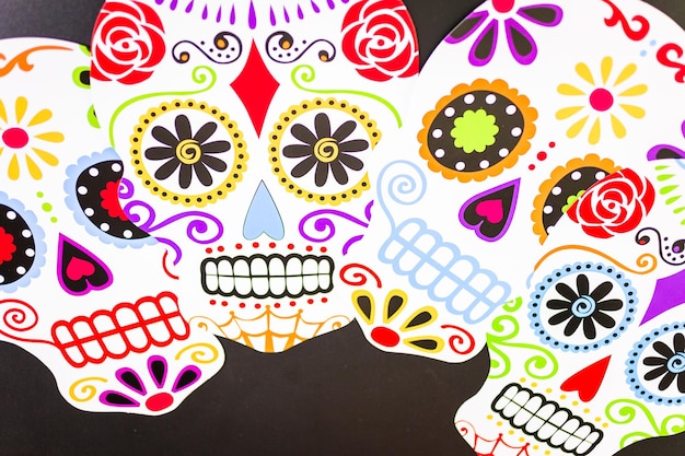 Decorations for traditional Mexican holiday Day of the Dead on a black background.