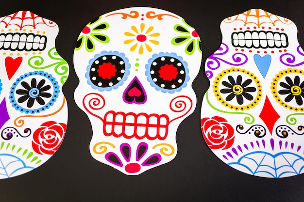 Decorations for traditional Mexican holiday Day of the Dead on a black background.