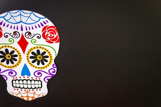 Decorations for traditional Mexican holiday Day of the Dead on a black background.