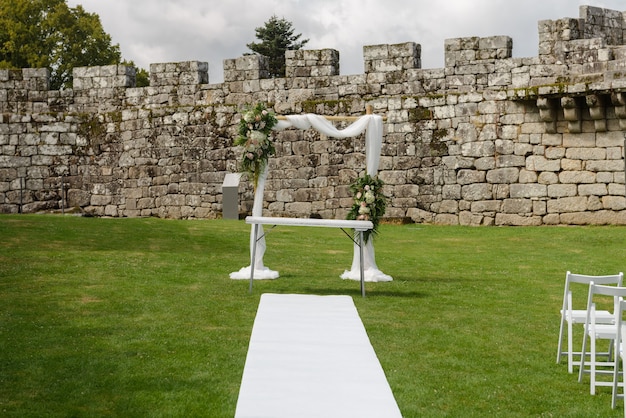 Decorations for the wedding ceremony on the green lawn of the old castle