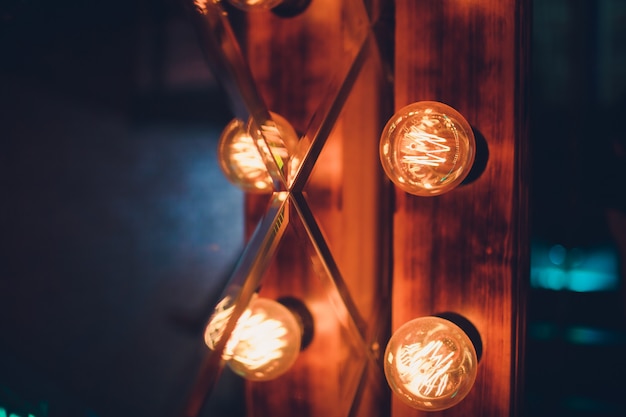 Decorative antique edison style light tungsten bulbs against brick wall background.