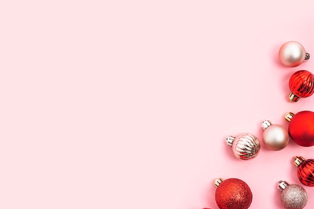 Decorative balls, empty space for text on a pink background. Top view, flat lay.