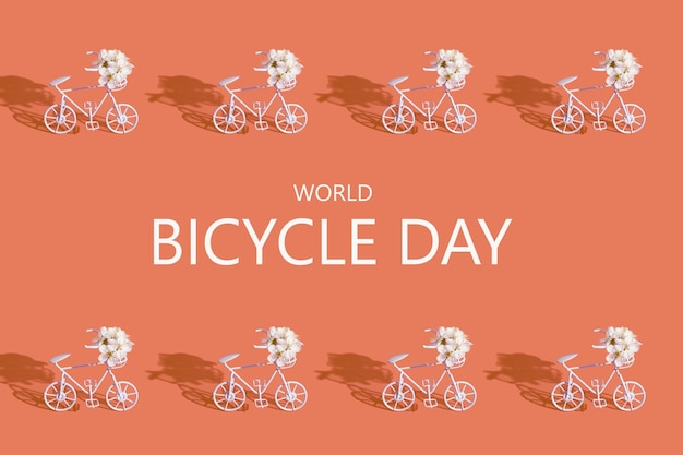 Photo decorative bicycles with flowers and text world bicycle day on orange background