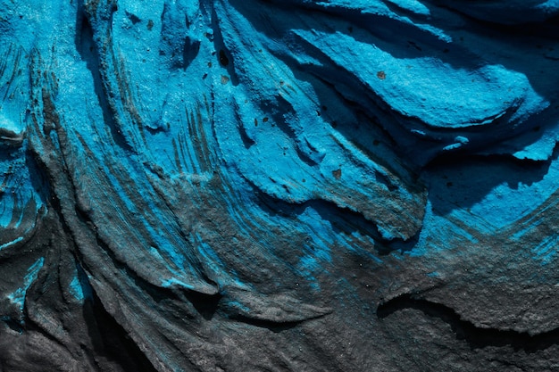 장식용 파란색 검은색 퍼티 배경 주걱으로 적용된 필러 페이스트가 있는 벽 텍스처