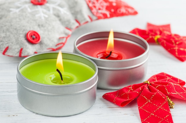 Decorative boot, bow and red lit candle