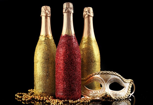 Decorative champagne bottles on dark background