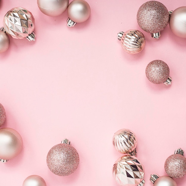 Decorative Christmas balls empty space for text on a pink background Top view flat lay