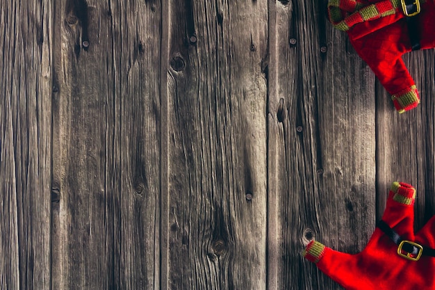 Decorative Christmas elf clothes on wooden background. Copy space. Selective focus.