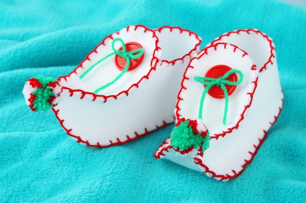 Decorative Christmas shoes on fabric background