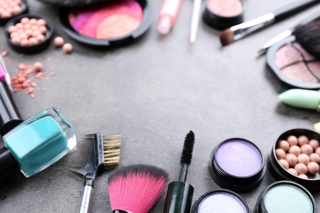 Decorative cosmetics laying out as a frame on grey background