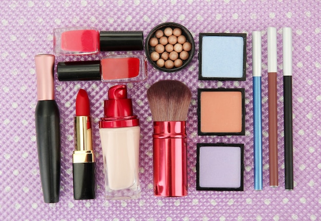 Decorative cosmetics on purple background