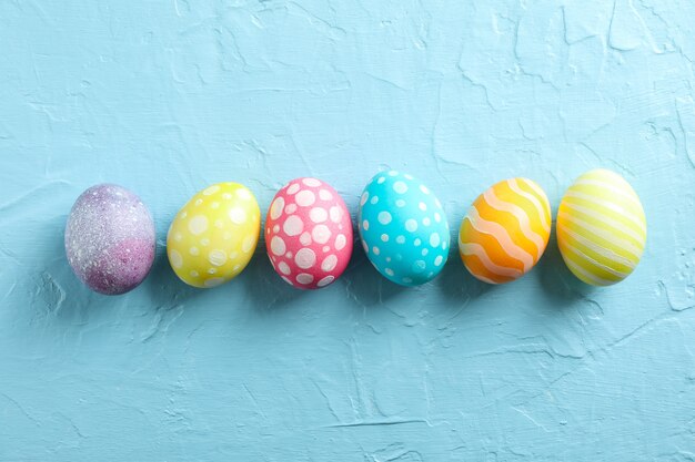 Decorative Easter eggs on color background