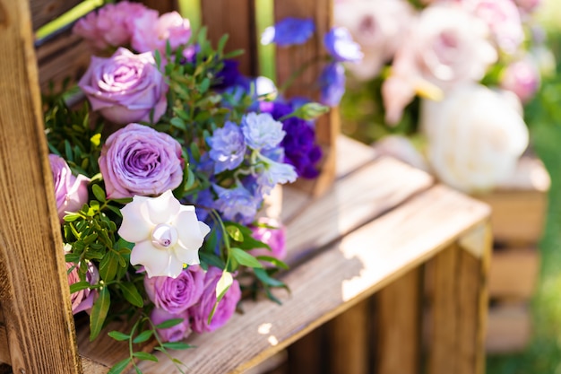 Decorative element from wooden boxes and fresh flowers. Details Party Decoration