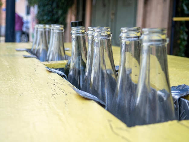 Decorative empty bottles table at the bar on the street bar decoration