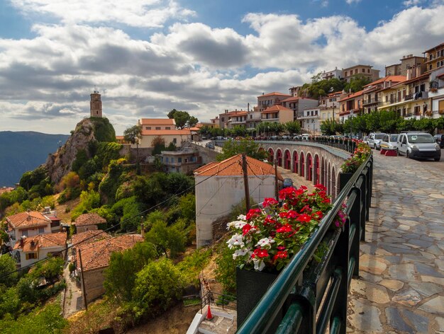 Decorative flowers in a pot on the background of the symbol symbol of city is the Arachova in Greece