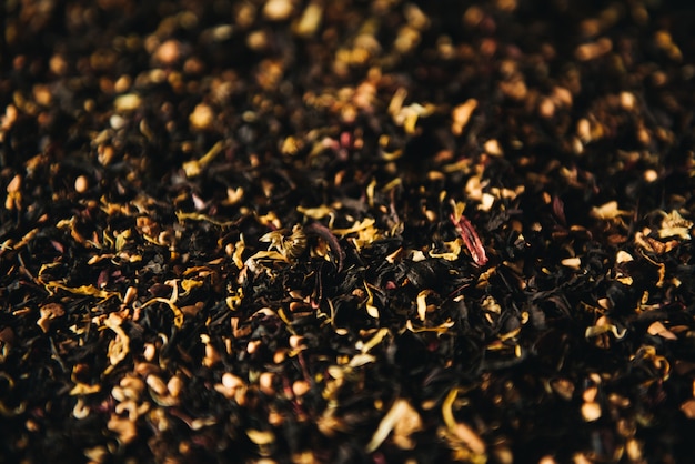 Decorative full frame image of dry green and black tea h fruit and flower additives Selective focus