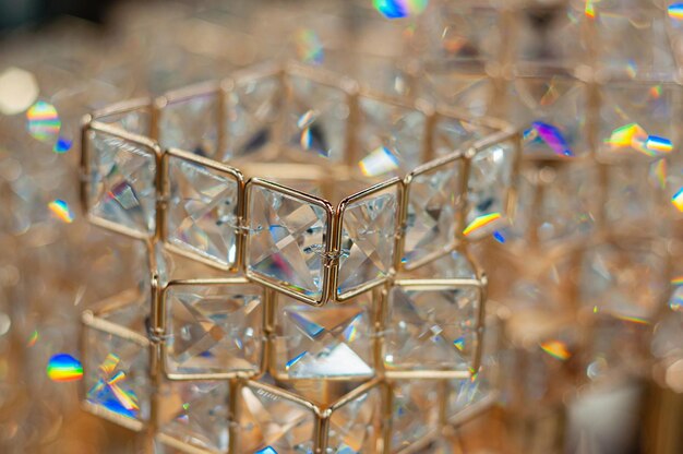 Decorative glass and gilded metal decoration on defocused background glare and reflections