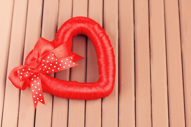 Decorative heart, on wooden background