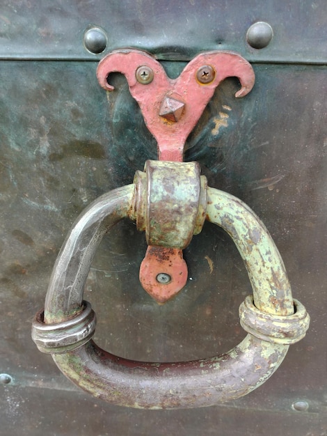 Decorative iron round handle on the wall of a pirate chest