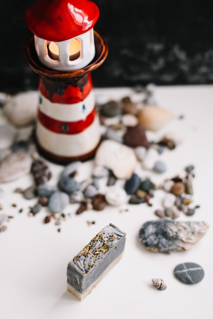 decorative lighthouse with sea shells and pebbles