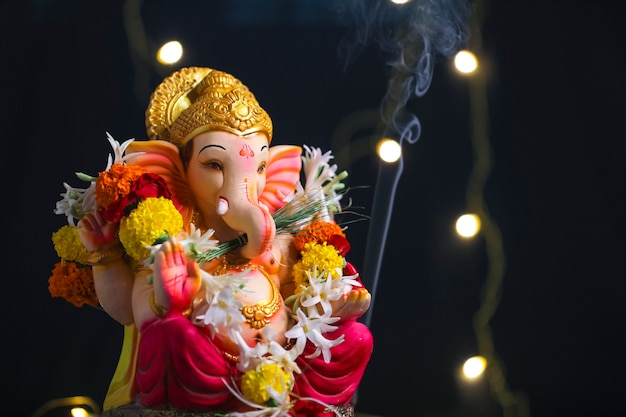 Decorative Lord ganesha sclupture on dark background.