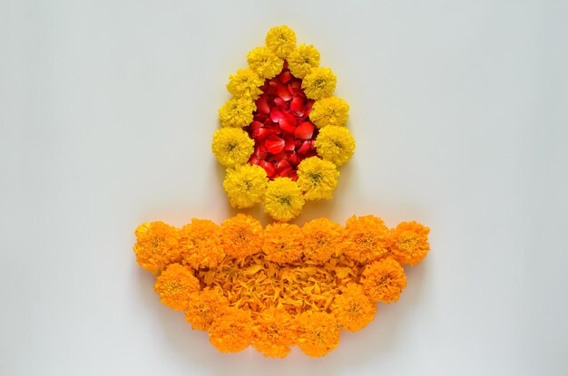 Decorative marigold flowers and rose petals rangoli for diwali
festival on white background