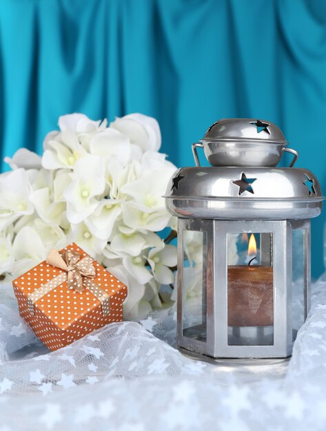 Decorative metallic lantern on fabric background