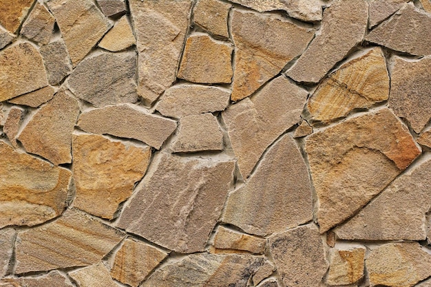 Decorative modern stone wall of chipped stone for background