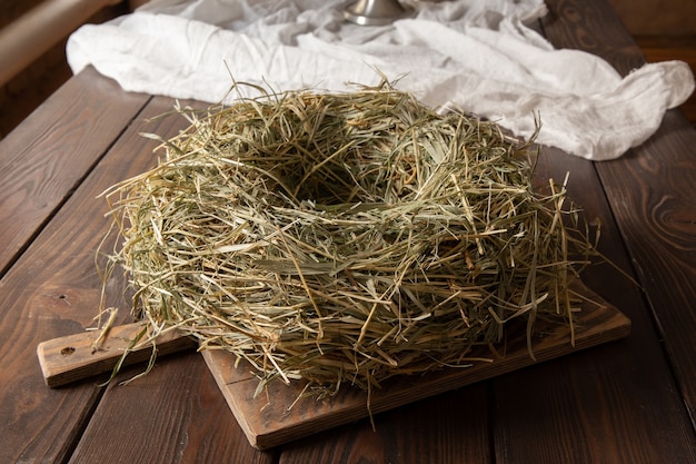 Decorative nest made of hay on a wooden table