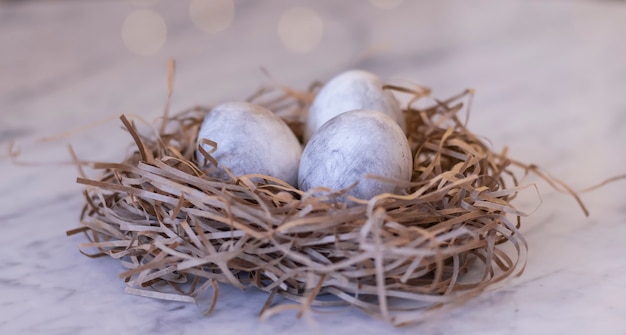 Decorative nest with colored Easter eggs in gray